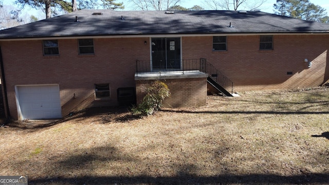 rear view of property featuring a garage