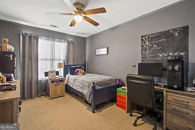 bedroom with ceiling fan and light carpet