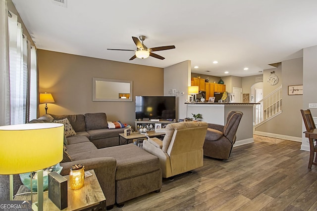 living room featuring ceiling fan and wood-type flooring