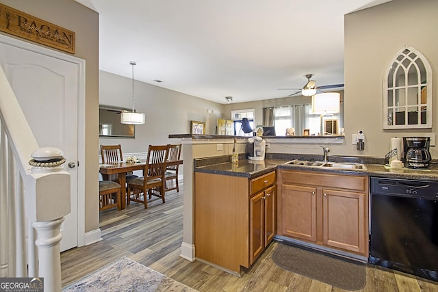 kitchen featuring kitchen peninsula, dishwasher, light hardwood / wood-style floors, ceiling fan, and sink