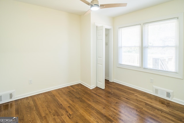 unfurnished bedroom with ceiling fan and dark hardwood / wood-style flooring