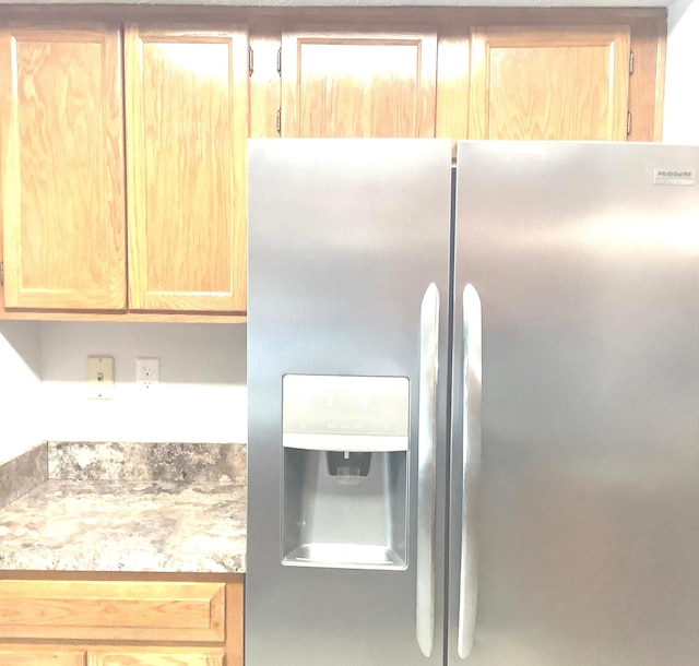 kitchen with stainless steel refrigerator with ice dispenser