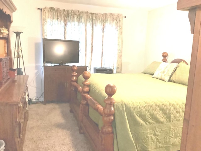 bedroom featuring light carpet