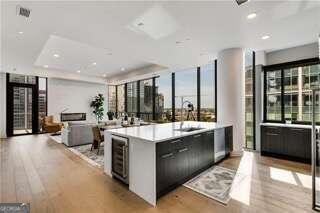 kitchen with a kitchen island with sink, a healthy amount of sunlight, and light hardwood / wood-style floors