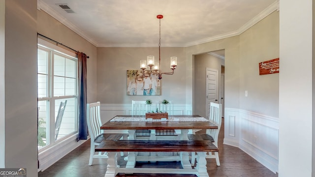 dining space featuring an inviting chandelier, dark hardwood / wood-style floors, and ornamental molding