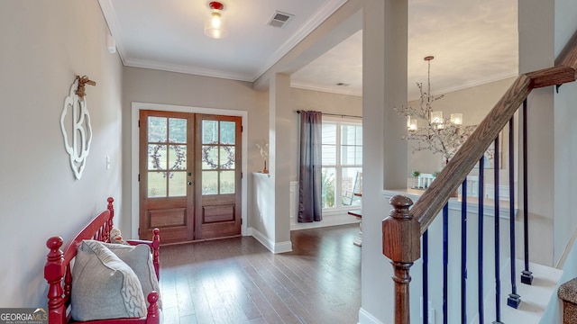 entrance foyer featuring plenty of natural light, crown molding, dark wood-type flooring, and french doors