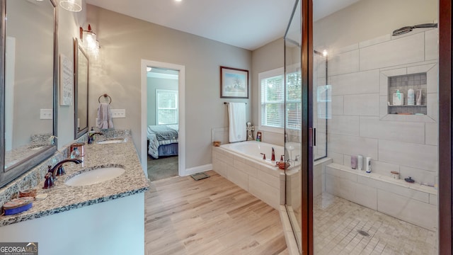 bathroom with vanity, hardwood / wood-style floors, plus walk in shower, and vaulted ceiling