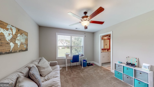 sitting room with ceiling fan and light colored carpet