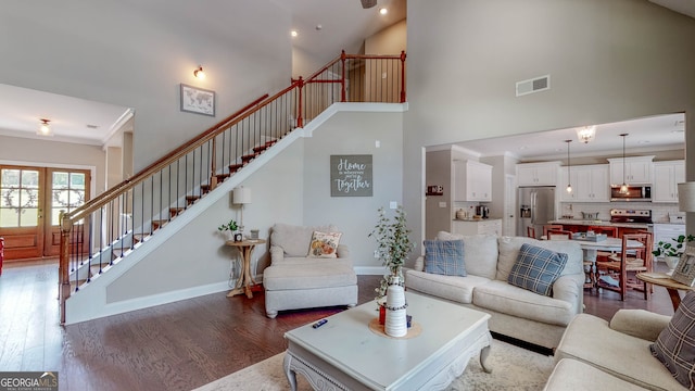 living room with dark hardwood / wood-style floors and high vaulted ceiling