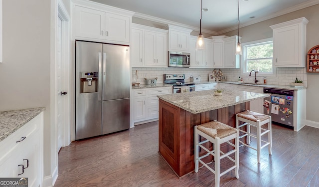 kitchen featuring light stone counters, dark hardwood / wood-style flooring, white cabinets, and appliances with stainless steel finishes