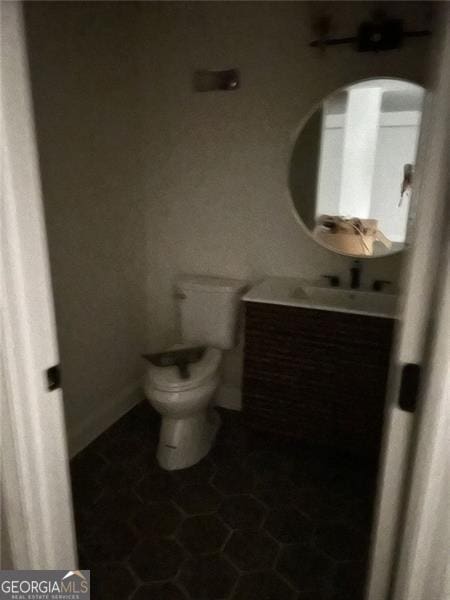 bathroom featuring tile patterned flooring, vanity, and toilet