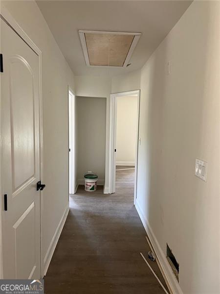 corridor featuring dark hardwood / wood-style flooring