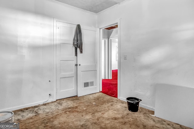 carpeted spare room with crown molding