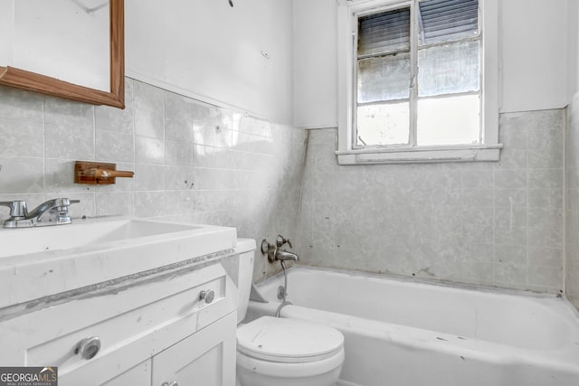 bathroom featuring a bathtub, vanity, tile walls, and toilet