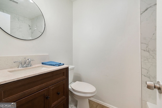 bathroom with vanity, hardwood / wood-style floors, and toilet