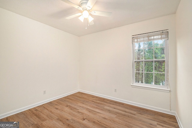 empty room featuring hardwood / wood-style flooring and ceiling fan