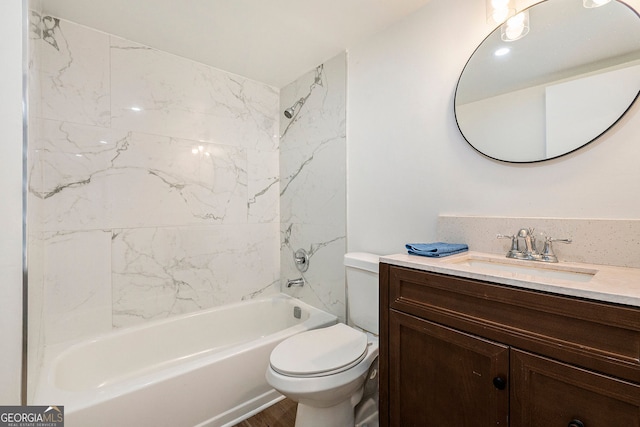 full bathroom with tiled shower / bath, vanity, and toilet