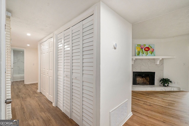 corridor with crown molding and hardwood / wood-style floors