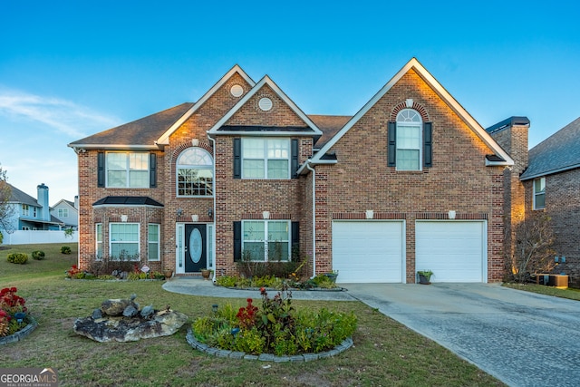 view of front facade with a front yard and a garage