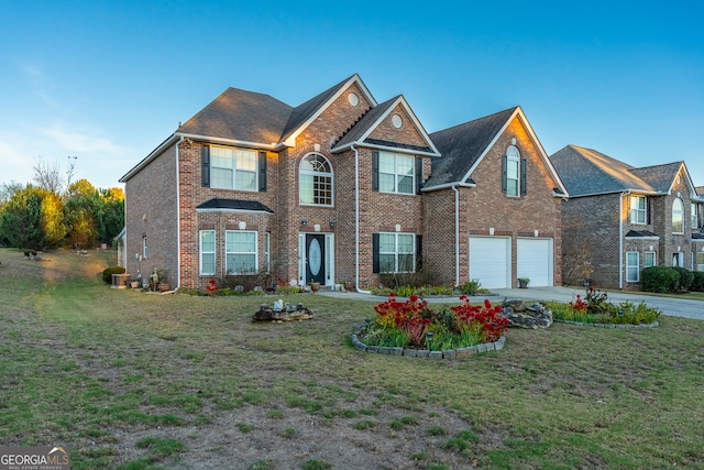 view of front of home featuring a garage and a front lawn