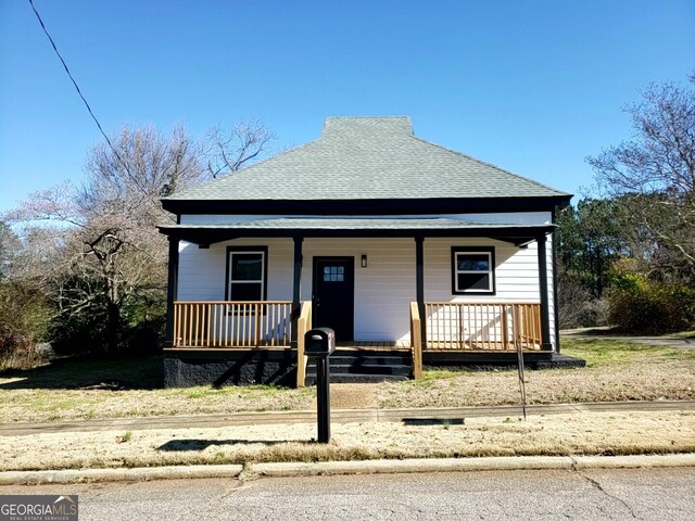 rear view of house with covered porch