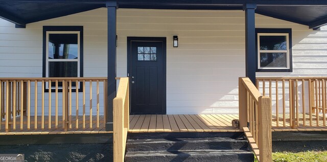 view of exterior entry with covered porch