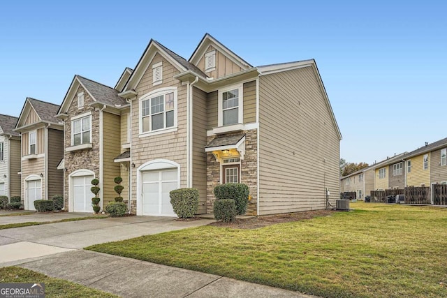 view of front of house featuring a garage, a front lawn, and central air condition unit