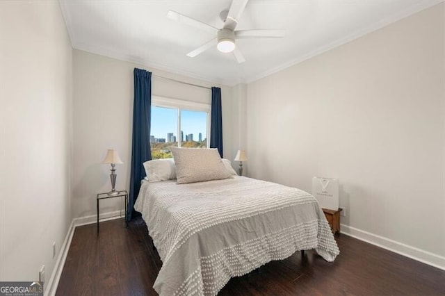 bedroom with a view of city, ornamental molding, wood finished floors, baseboards, and ceiling fan