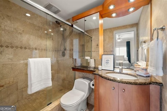 full bathroom featuring visible vents, toilet, a stall shower, and vanity