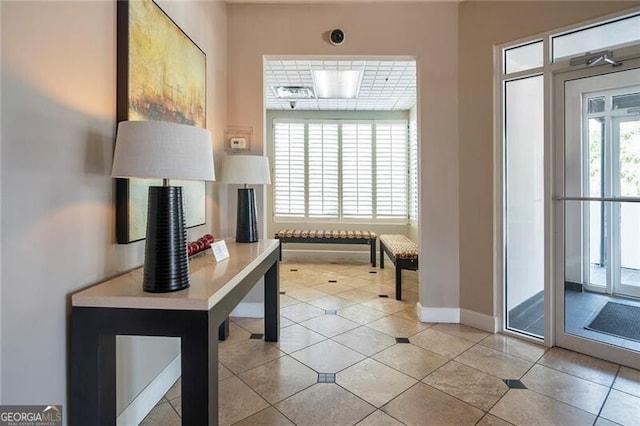 entryway featuring light tile patterned floors and baseboards