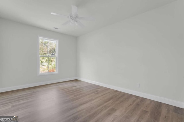2005 Washington St, Savannah, GA 31406 - spare room with wood finished floors, baseboards, and a ceiling fan