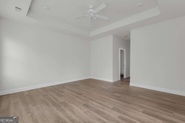 2005 Washington St, Savannah, GA 31406 - unfurnished room with a raised ceiling, baseboards, light wood finished floors, and ceiling fan