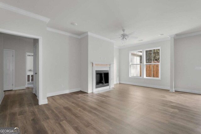2005 Washington St, Savannah, GA 31406 - unfurnished living room featuring crown molding, wood finished floors, a fireplace with flush hearth, a ceiling fan, and baseboards