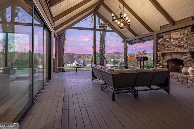 deck at dusk with an outdoor living space with a fireplace