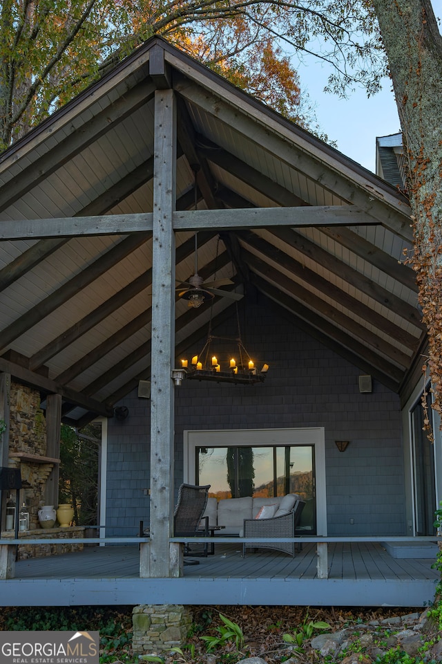 rear view of house with outdoor lounge area, ceiling fan, and a wooden deck