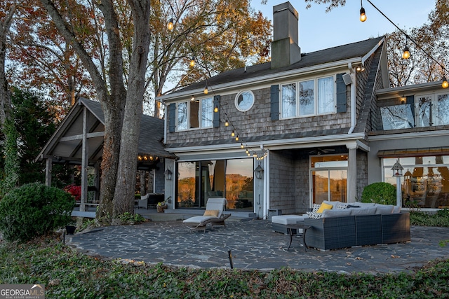 back of property featuring an outdoor hangout area and a patio