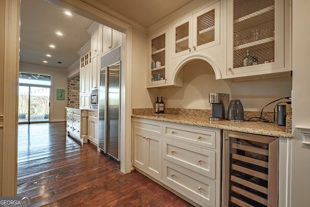 kitchen featuring stainless steel built in refrigerator, dark hardwood / wood-style flooring, beverage cooler, and ornamental molding