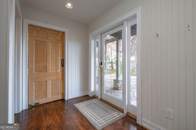 doorway to outside featuring dark hardwood / wood-style flooring and ornamental molding