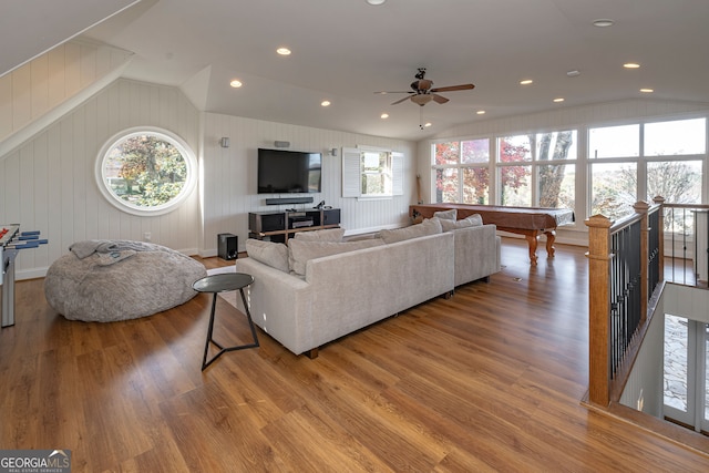 living room with a wealth of natural light, ceiling fan, wood-type flooring, and pool table