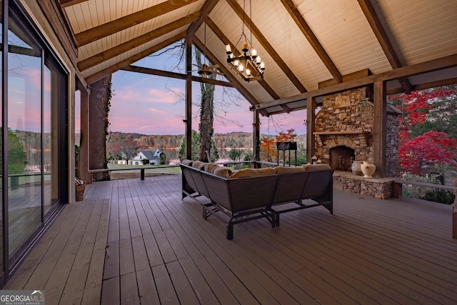 deck at dusk featuring an outdoor living space with a fireplace