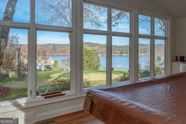 sunroom / solarium featuring a water view and pool table