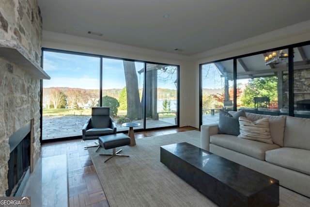 sunroom / solarium with a stone fireplace