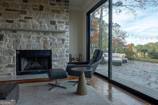 interior space with a fireplace, hardwood / wood-style flooring, and ornamental molding