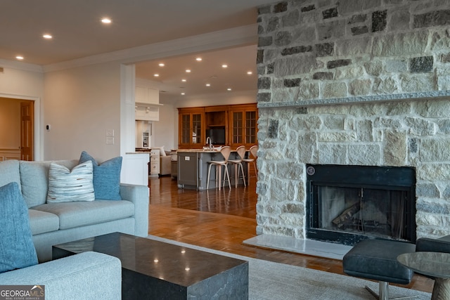 living room with dark hardwood / wood-style floors, a fireplace, and crown molding