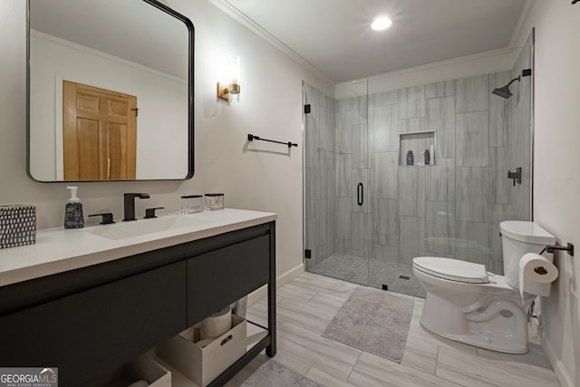 bathroom with vanity, toilet, a shower with shower door, and crown molding