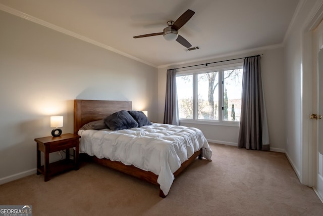 carpeted bedroom featuring ceiling fan and ornamental molding