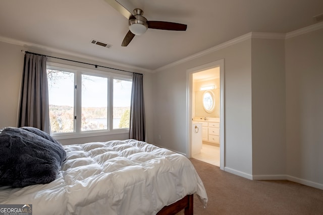 bedroom with light carpet, connected bathroom, ceiling fan, and ornamental molding