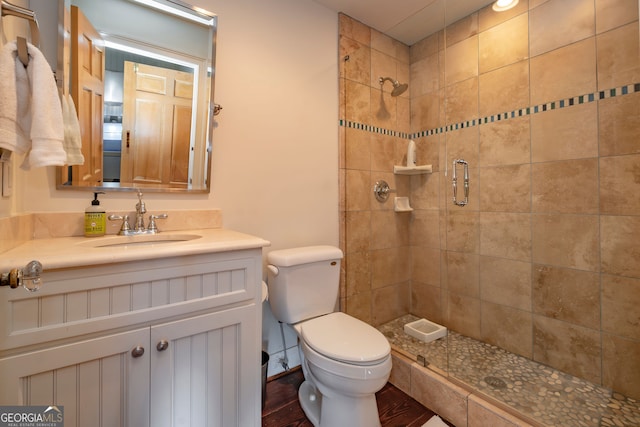 bathroom with vanity, toilet, wood-type flooring, and walk in shower