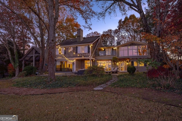 view of back house at dusk