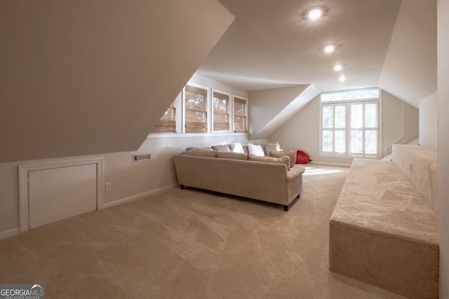 bonus room featuring a wealth of natural light, light carpet, and lofted ceiling